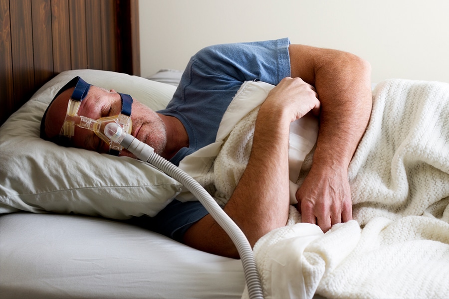 Sleeping man with CPAP